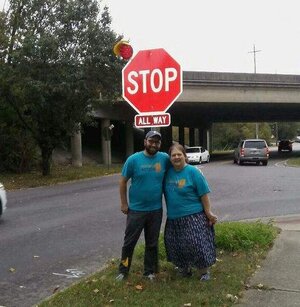 Will and Myra in front of new stop sign